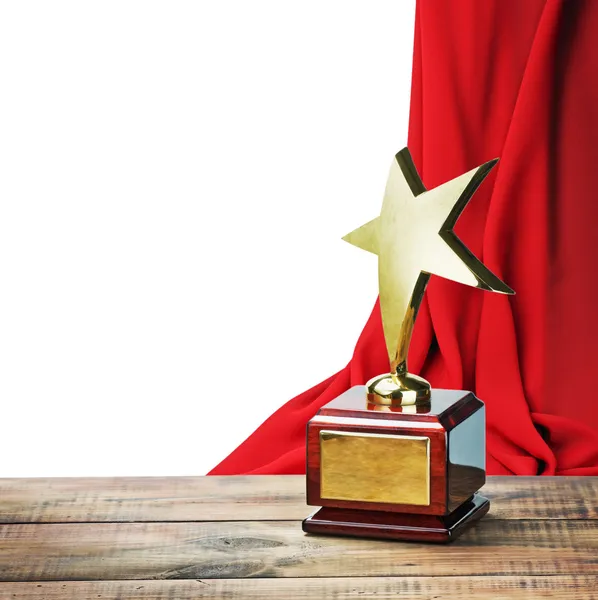 Звезда премии деревянный стол и на фоне красный занавес Лицензионные Стоковые Фото
