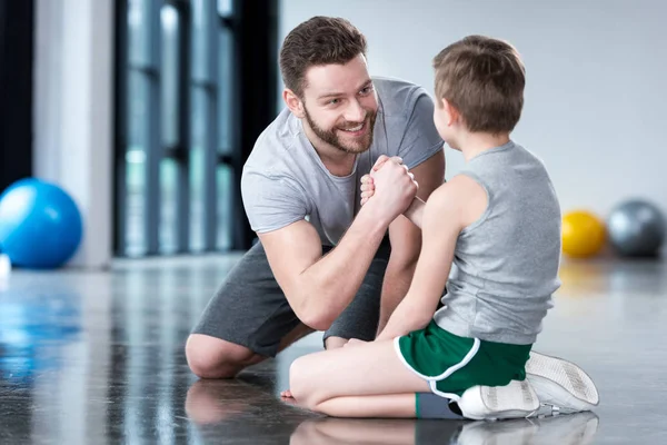 Мальчик с молодым человеком в фитнес-центре Лицензионные Стоковые Изображения