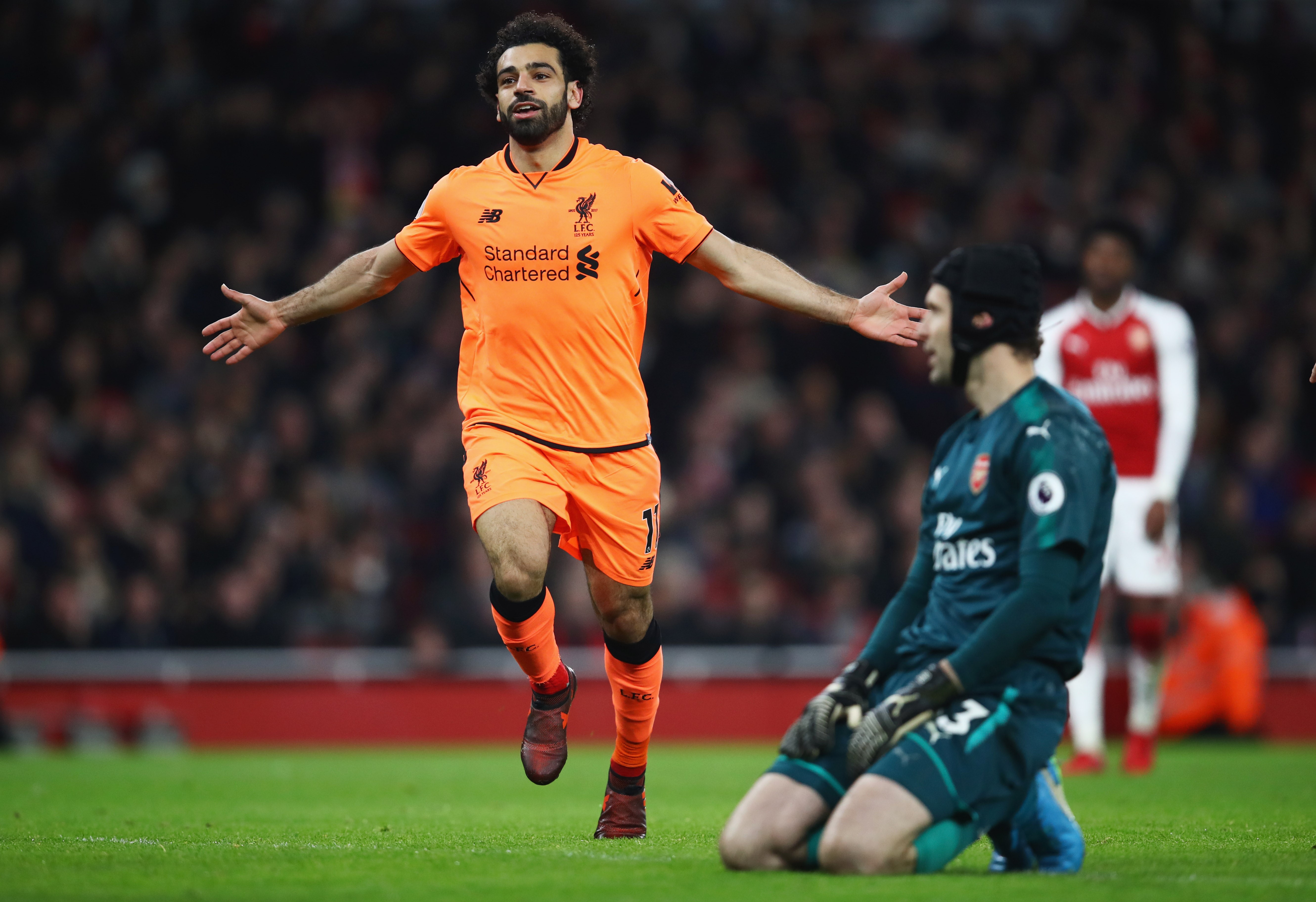 Mohamed Salah of Liverpool celebrates as he scores their second goal as Petr Cech of Arsenal looks dejected during the Premier League match between Arsenal and Liverpool at Emirates Stadium on December 22, 2017 in London, England.